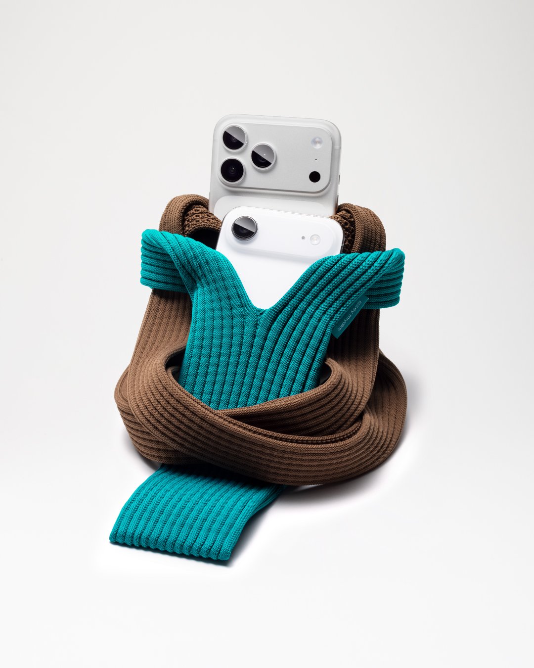 iPhone Pocket by ISSEY MIYAKE — long strap design in cinnamon with iPhone 17 Pro in silver, short strap design in peacock with iPhone Air in cloud white.jpg